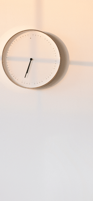 Analog clock on a blank wall